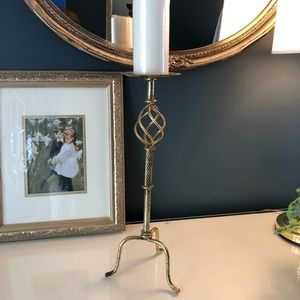 Tall burnished gold candlestick.